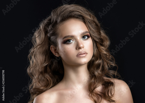 Obraz na plátně A girl with beautiful golden eye makeup and curly hair