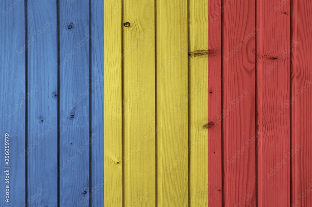 Fototapeta premium Flag of Romania on the background of wooden boards. Wallpaper for installation and design. Space for text.