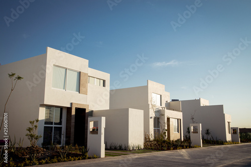 New modern houses perfect for living, sunny day and blue sky © JesusCarreon