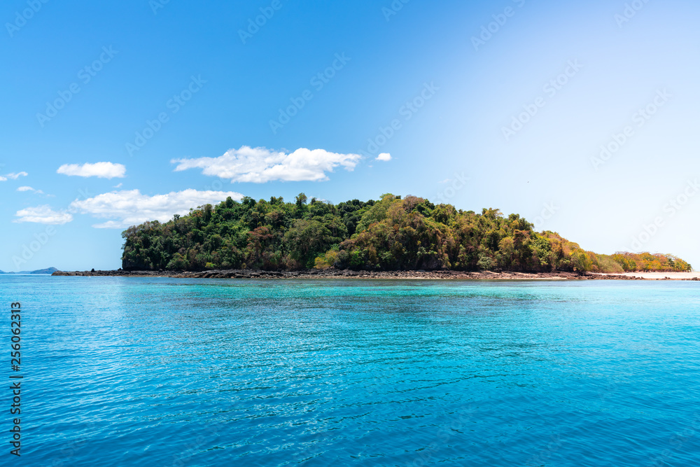 beautiful picture of an island in the ocean on a sunny day