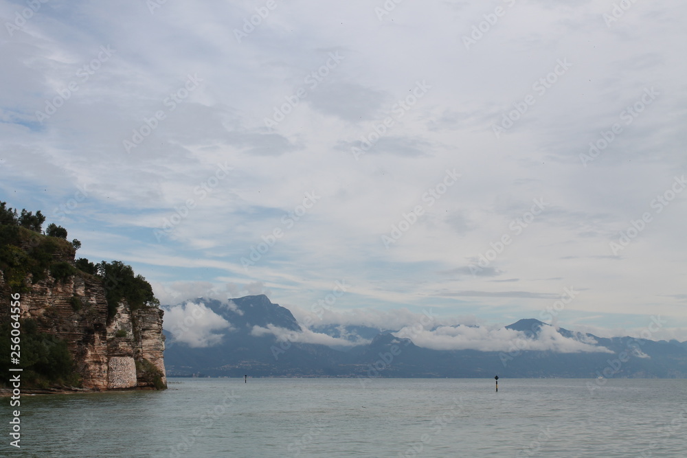 Low white clouds on lake Garda Sirmione Italy