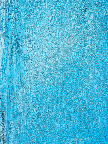 old blue paint in cracks on the wooden wall