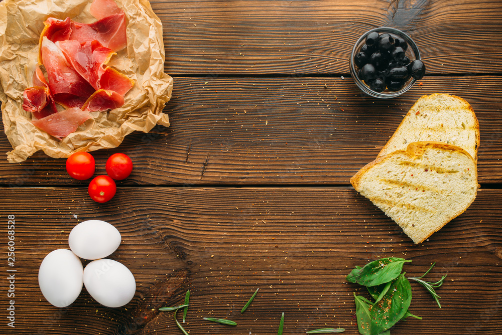 Raw meat in seasoning, olives, herb and eggs Raw meat in seasoning, olives, herb and eggs