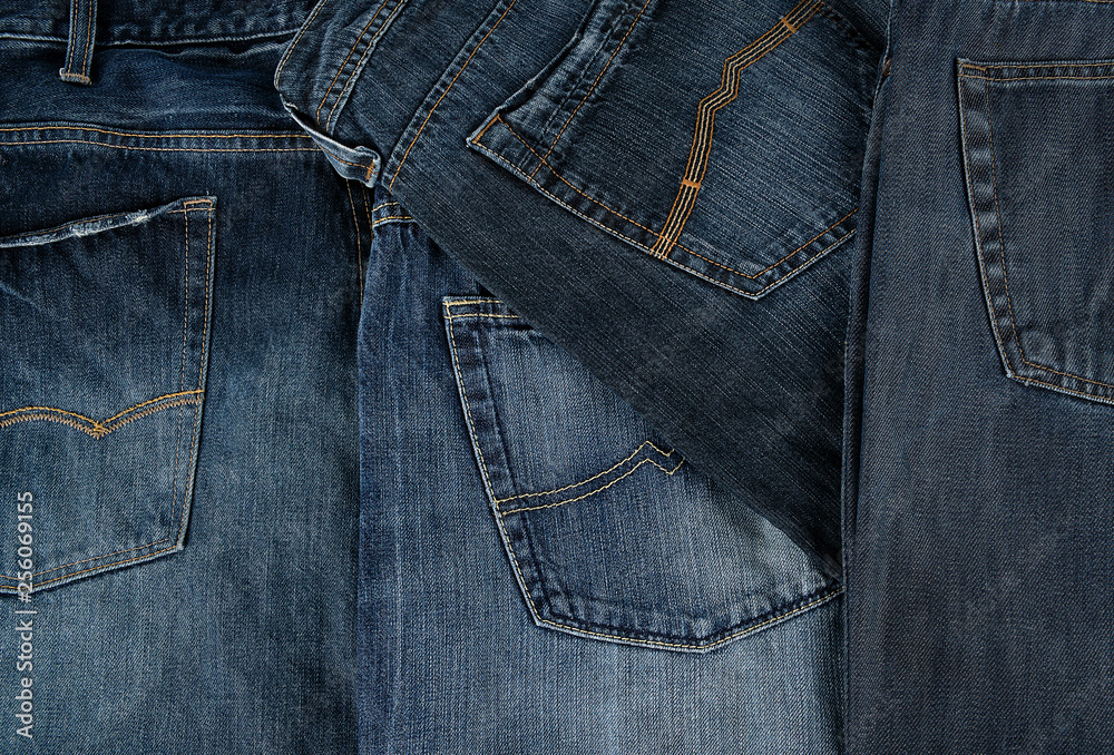 Lots of blue classic jeans stacked chaotically Lots of blue classic jeans stacked chaotically