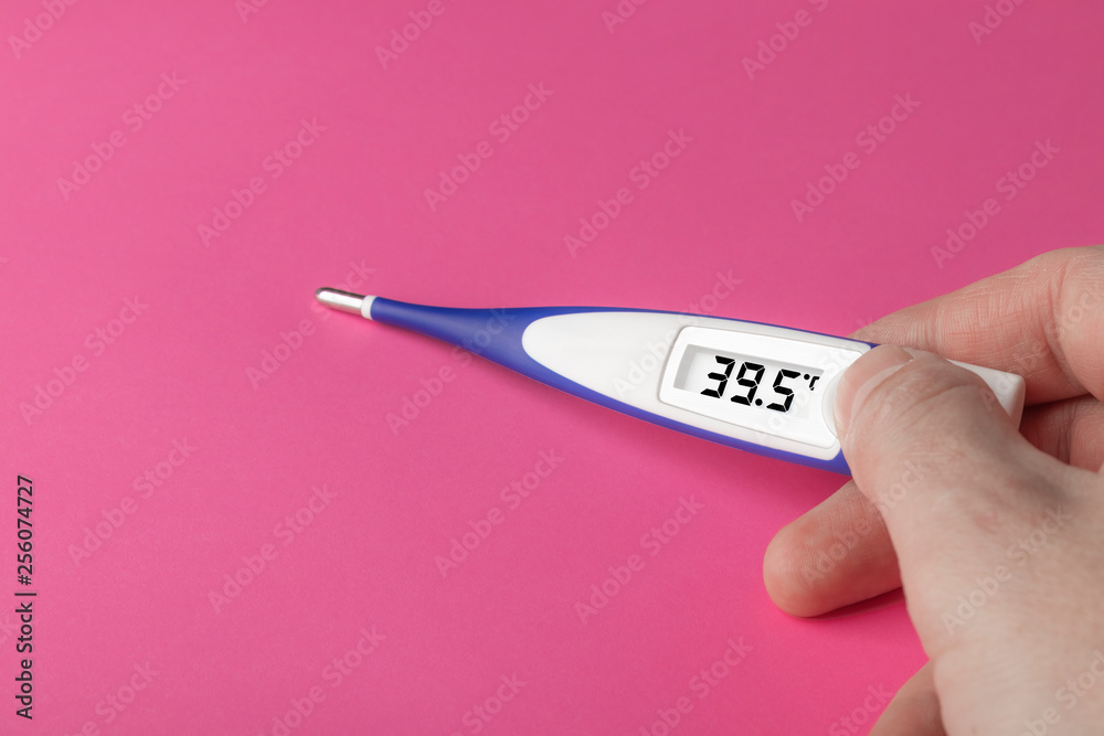 White-blue thermometer with a high temperature of 39.5 degrees Celsius in  hand Photos | Adobe Stock