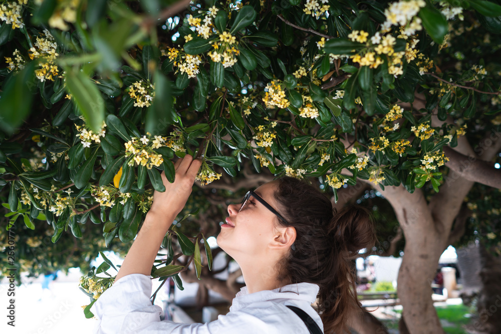 Beautiful woman smelling trees' flowers. Spring time Beautiful woman smelling trees' flowers. Spring time