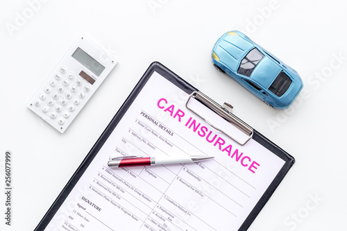 Car insurance concept with form, car toy and calculator on white background top view