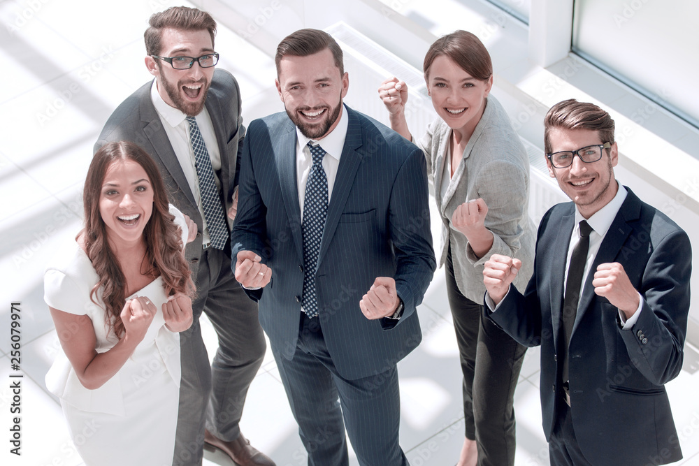 top view.happy business team showing their success top view.happy business team showing their success