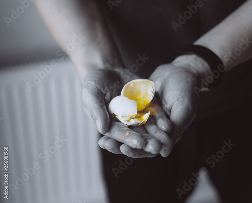 The guy holding the crushed egg, close view