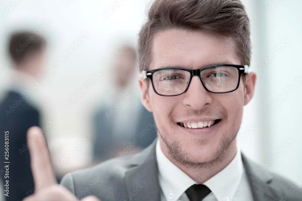 close up.careful young business man in blurred background. close up.careful young business man in blurred background.
