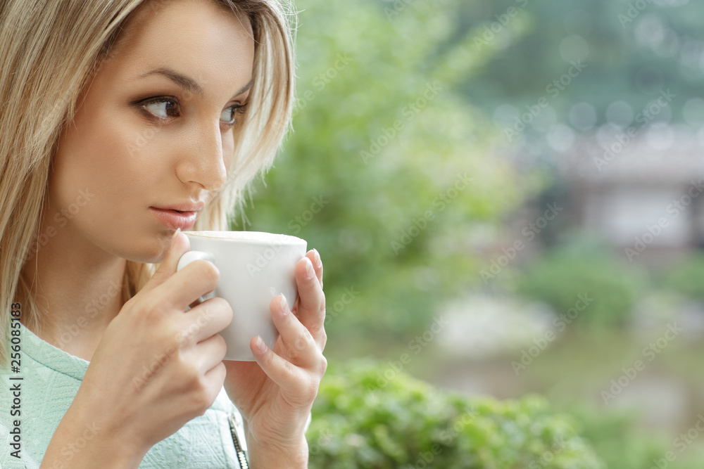 Morning coffee. Close up shot of a beautiful female holding a cup of coffee going to drink the beverage Morning coffee. Close up shot of a beautiful female holding a cup of coffee going to drink the beverage