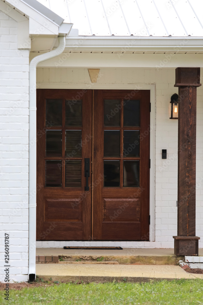 Front Door of a White Brick 1980's Traditional Standard Home House that has been Updated Fixer Upper