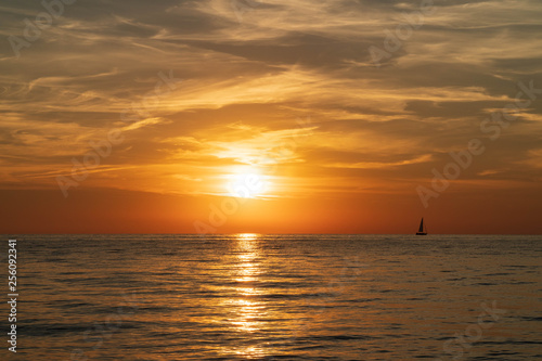 Sunset on a beautiful sky on a deserted seashore © potas