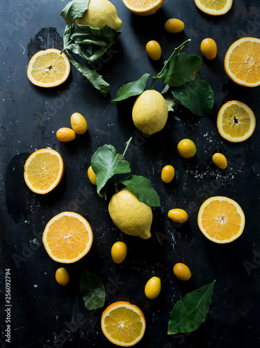 Citrus fruit top view,lemon and orange fruit, on a black dark board, top view, natural light