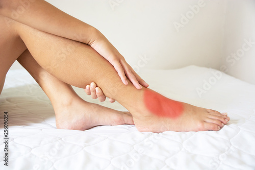 Young woman, ankle pain, she is massage