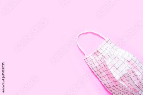 Protective Face Mask Symbol for Dust Protection Sector. Safety Mask (Pink Scotch Pattern) for Air Pollution Street. Single Pink Pastel Medical Mask Isolated on Pink Color Background, Top View.