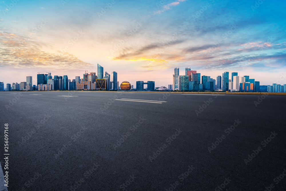 Foreground highway asphalt pavement city building commercial building office building Foreground highway asphalt pavement city building commercial building office building
