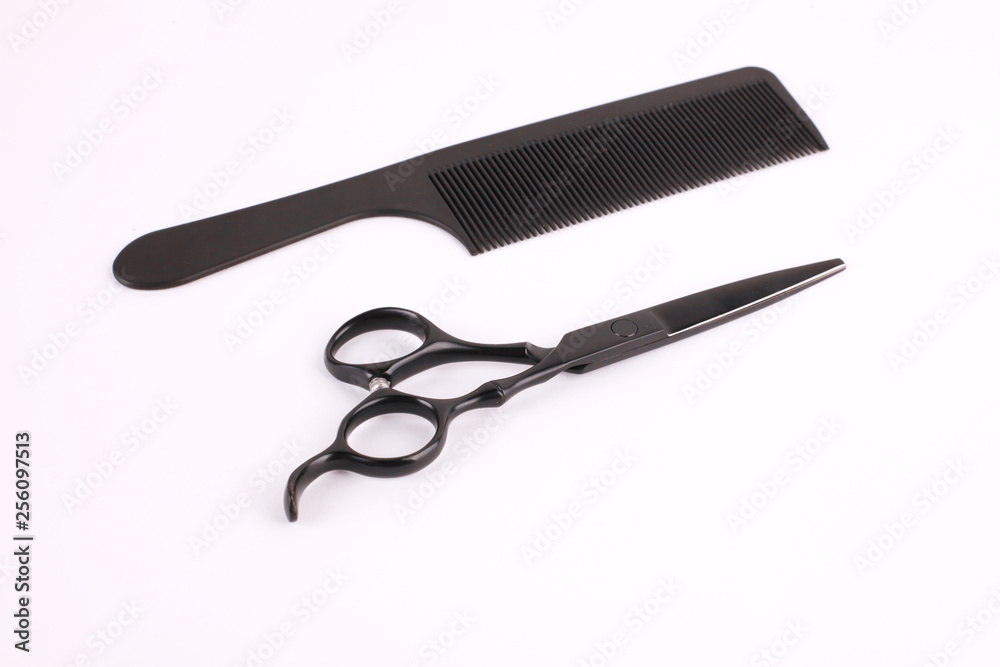 Barber scissors and a hairbrush isolated on white background Barber scissors and a hairbrush isolated on white background