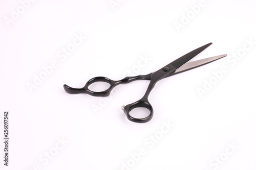 Barber scissors and a hairbrush isolated on white background