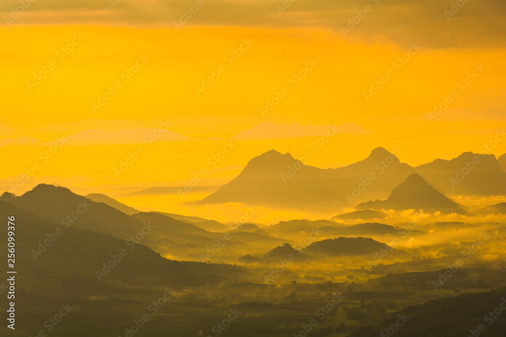 Landscape mountain range with fog mist colorful sunrise in the morning