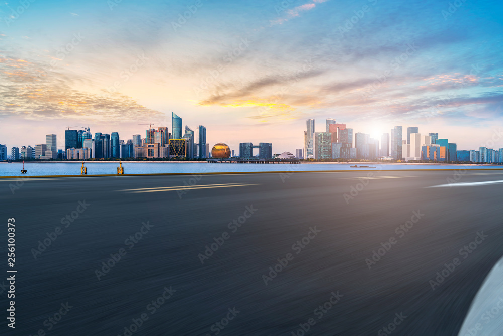 Foreground highway asphalt pavement city building commercial building office building Foreground highway asphalt pavement city building commercial building office building