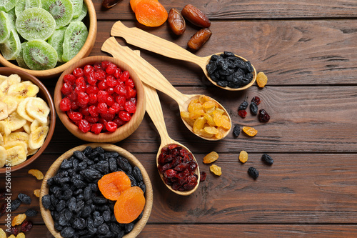 Fototapeta Naklejka Na Ścianę i Meble -  Flat lay composition with different dried fruits on wooden background, space for text. Healthy lifestyle