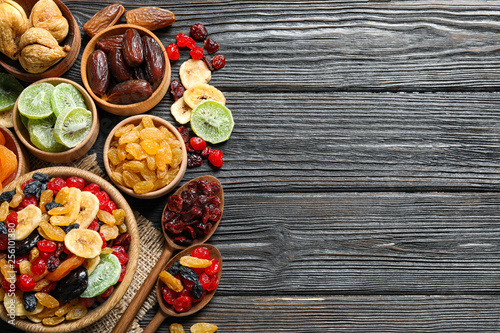 Fototapeta Naklejka Na Ścianę i Meble -  Flat lay composition with different dried fruits on wooden background. Space for text