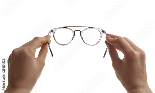 Female ophthalmologist holding glasses on white background, closeup