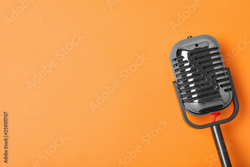 Retro microphone on color background, top view with space for text. Musical equipment