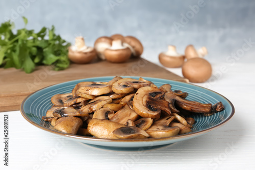 Plate of fried mushrooms on table, closeup