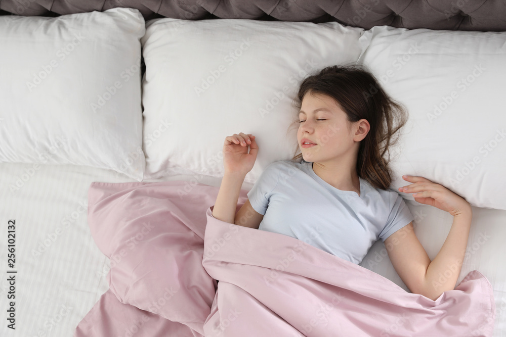 Beautiful little girl sleeping in bed, top view. Space for text Beautiful little girl sleeping in bed, top view. Space for text