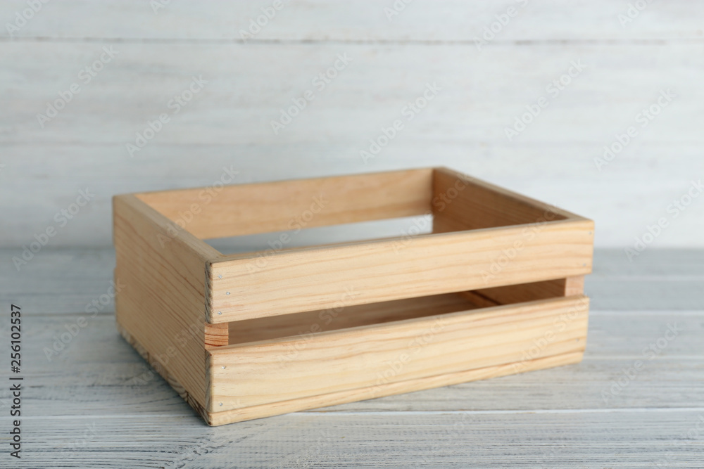 Wooden crate on table against light background. Space for text