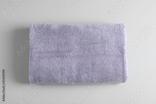 Fresh fluffy towel on grey background, top view. Mockup for design