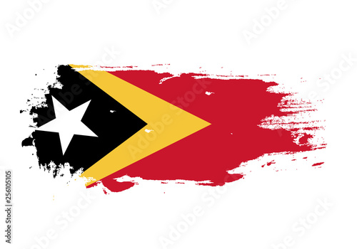 Grunge brush stroke with East Timor national flag. Watercolor painting flag. Symbol, poster, banner of the national flag. Vector Isolated on white background.