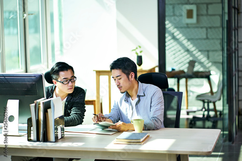 Photography two asian business men working together in office