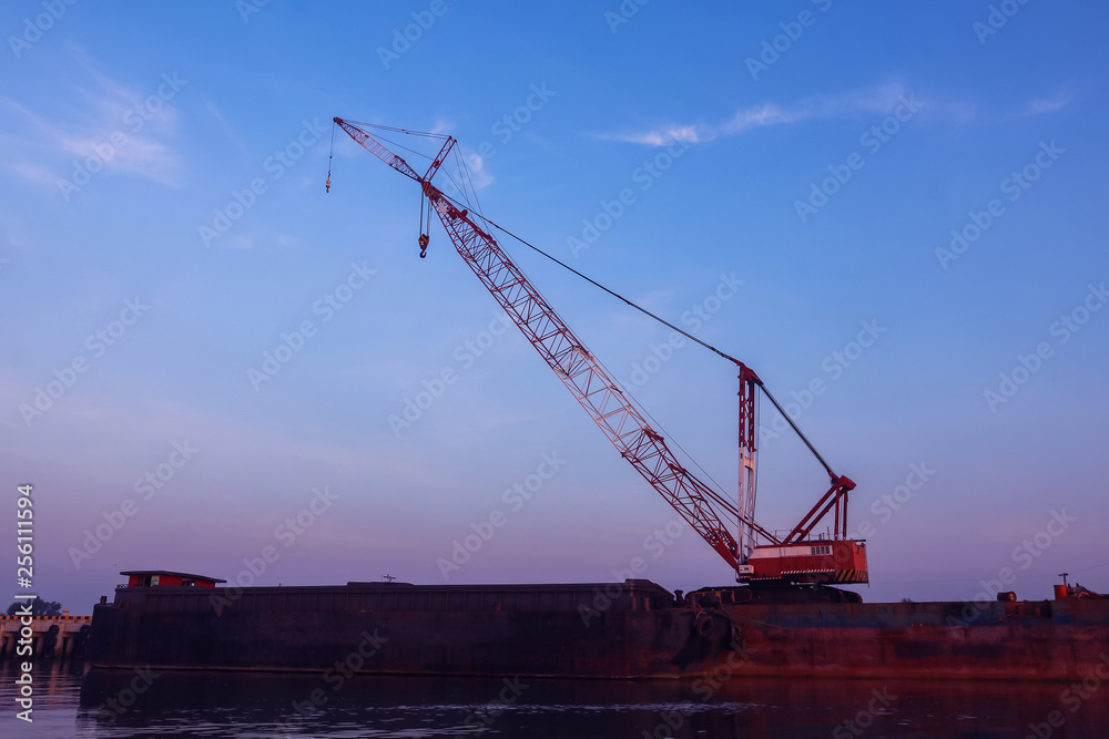 Crawler cranes used for rebuilding bridges near the river Crawler cranes used for rebuilding bridges near the river