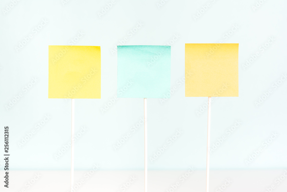 Three adhesive paper notes on stick. Empty board plank holder. Three adhesive paper notes on stick. Empty board plank holder.