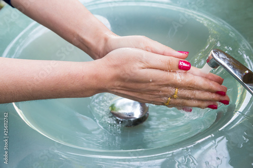 Woman with red nail Cleaning Hands, Washing hands on blue sink