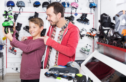 Father and son examining various roller-skates