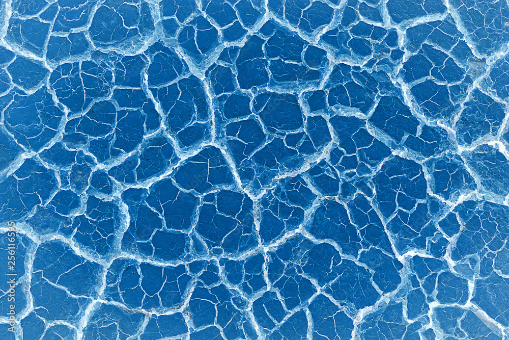 Fototapeta premium Abstract Crack soil on dry season/Global worming effect on blue color