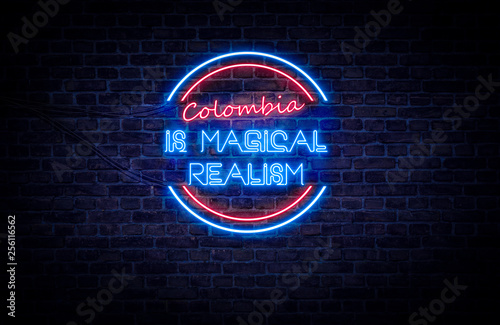 A red and blue neon light sign that reads: Colombia is magical realism photo