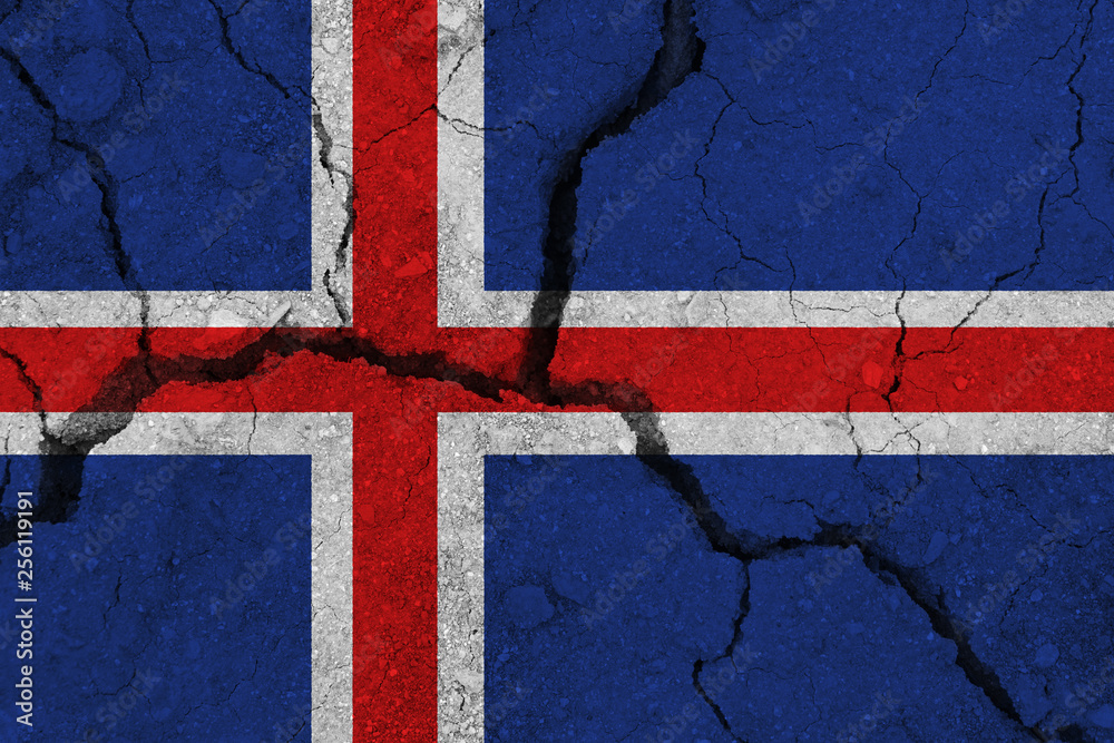Fototapeta premium Iceland flag on the cracked earth