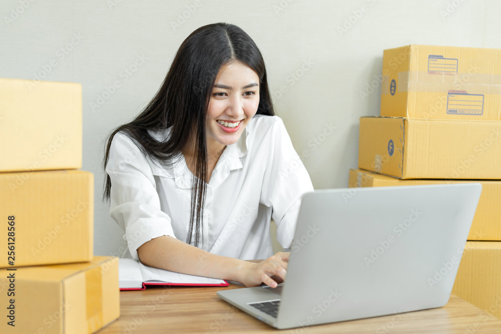 Beautiful Asian business young woman fell happy after receiving the email ordering product,startup small business owner working with computer at home office ,online market packaging box for delivery Beautiful Asian business young woman fell happy after receiving the email ordering product,startup small business owner working with computer at home office ,online market packaging box for delivery