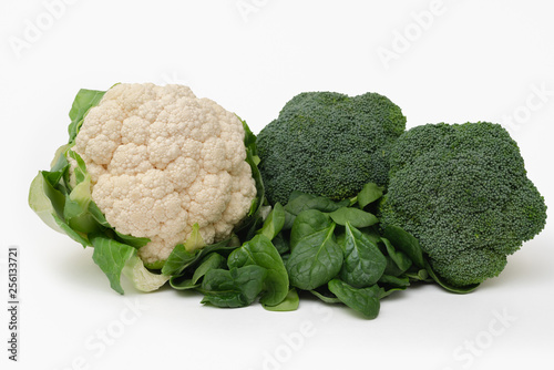 Fresh vegetable isolated on white. Cauliflower, broccoli, haricots, tomatoes, and spinach close up