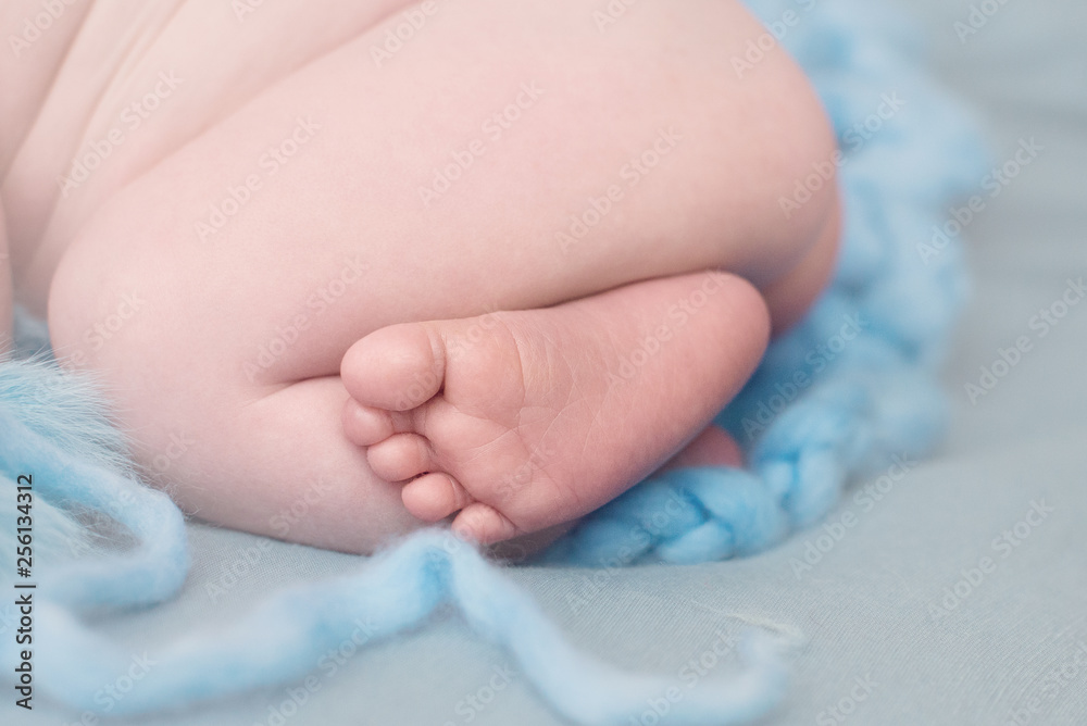 Feet of a newborn baby, toes and nails of a child, the first days of life after birth, scaly skin of legs Feet of a newborn baby, toes and nails of a child, the first days of life after birth, scaly skin of legs