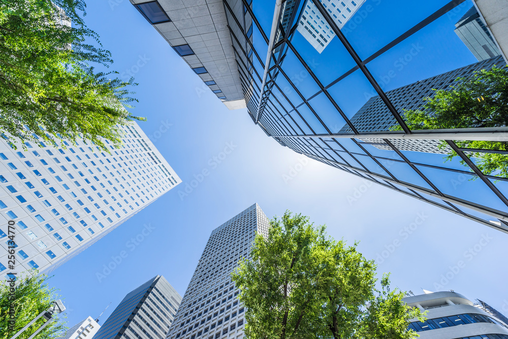 Asia Business concept for real estate, corporate construction and ecology - looking up view of panoramic modern city skyline with blue sky and green tree in shinjuku, tokyo, japan - obrazy, fototapety, plakaty 