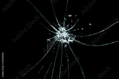 broken cracked glass with hole in black background
