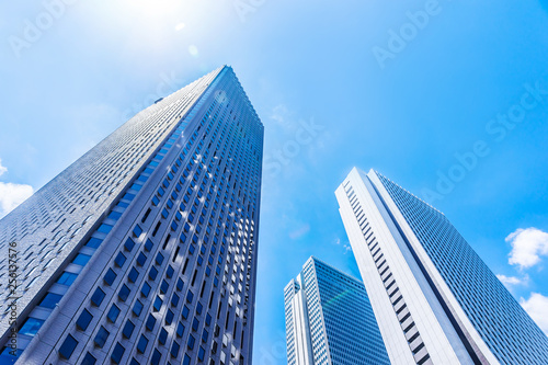Asia Business concept for real estate and corporate construction - looking up view of panoramic modern city skyline with blue sky in shinjuku  tokyo  japan
