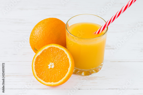 Fresh orange juice on white wooden background. Summer vitamin drinks
