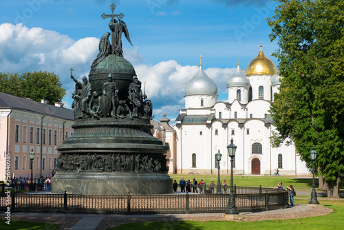 VELIKY NOVGOROD, RUSSIA - AUGUST 14, 2018: Monument Millenium of Russia on the background of St. Sophia Cathedral with tourists walking along in summer day